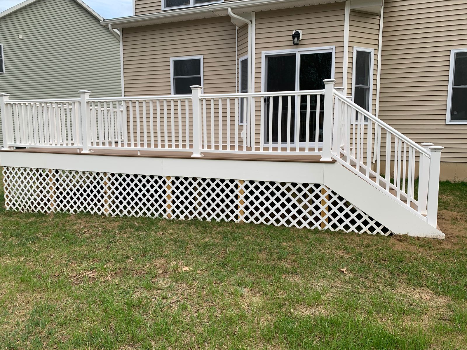Deck with white railings, stairs and lattice skirting