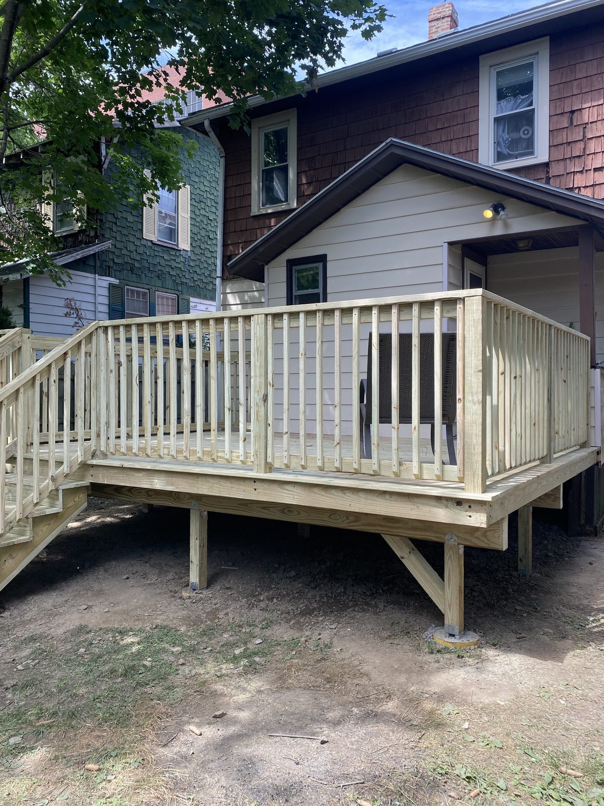 Raised pressure-treated deck with railings and stairs