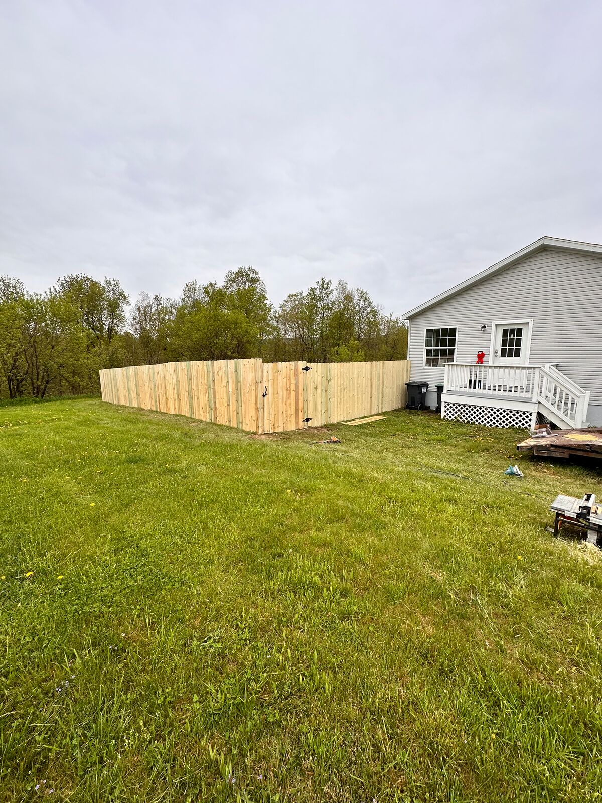 Wood privacy fence enclosing a backyard