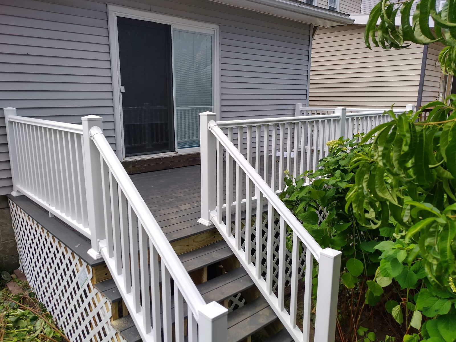 Stairs with white railings and lattice skirting