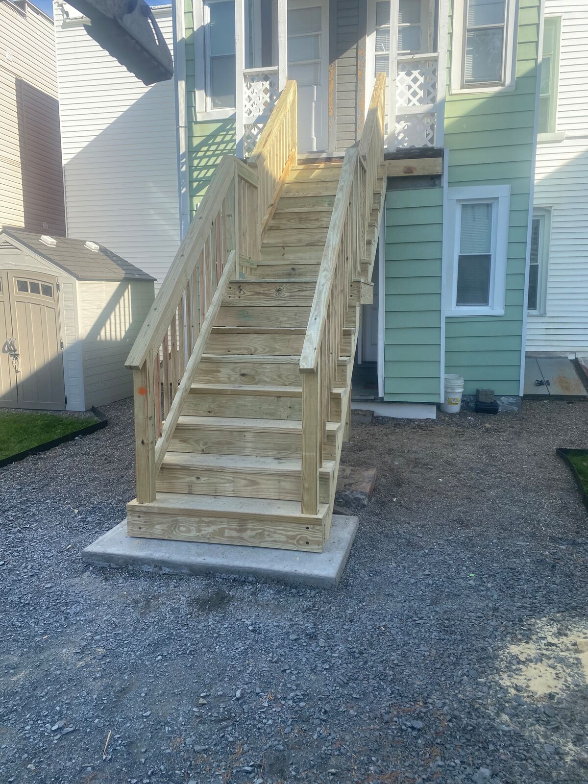 Pressure-treated exterior stairs to a second-floor porch
