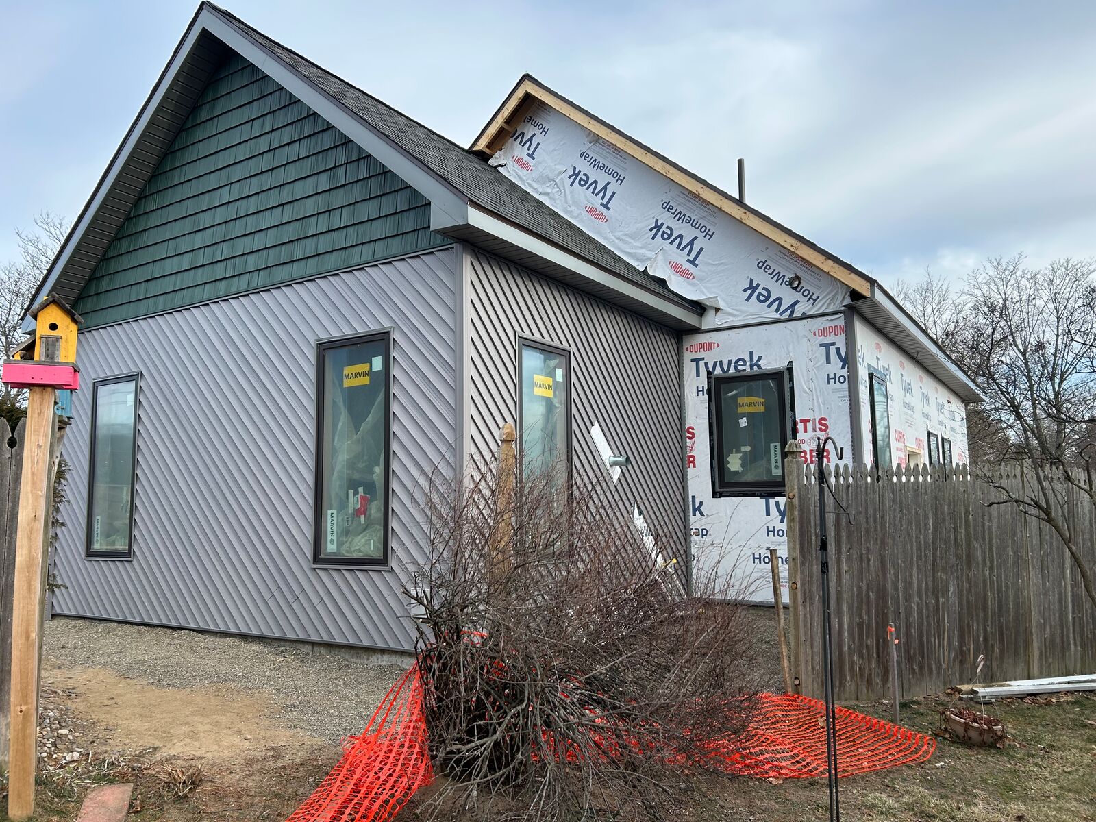 New siding and shake-style gable on an addition, house wrap in progress